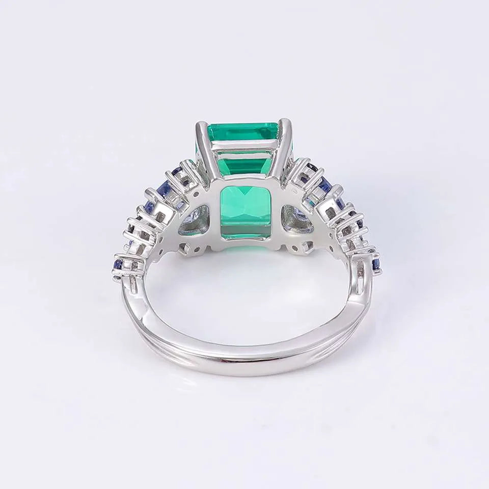 10K-18K , Emerald Ring With Trillion Sapphires And Dark-Colored Rounds