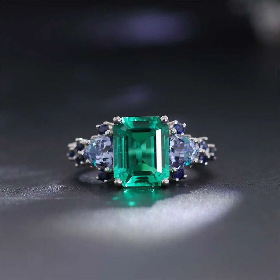 10K-18K , Emerald Ring With Trillion Sapphires And Dark-Colored Rounds