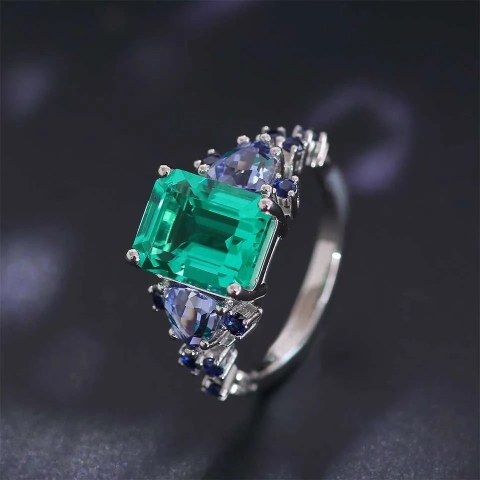 10K-18K , Emerald Ring With Trillion Sapphires And Dark-Colored Rounds